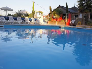 Pool surrounded by sun loungers