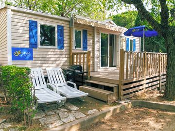 Exterior of an Emerald three-bed caravan, with terrace