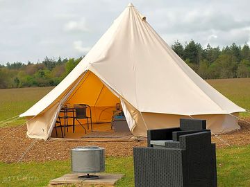 Exterior photo of our deluxe bell tent with firepit