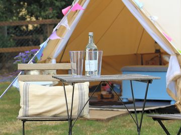 Table and chairs outside each tent