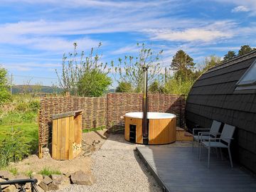 Outdoor space with hot tub and seating area