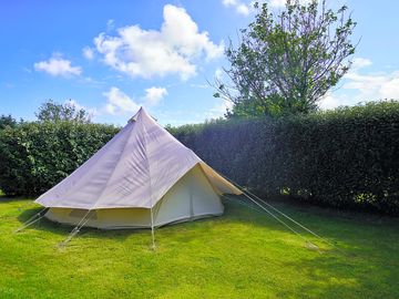 Bell tent with grass area and parking
