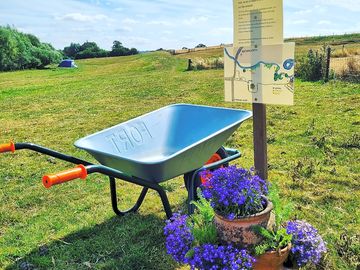 Welcome sign and wheelbarrow collection point