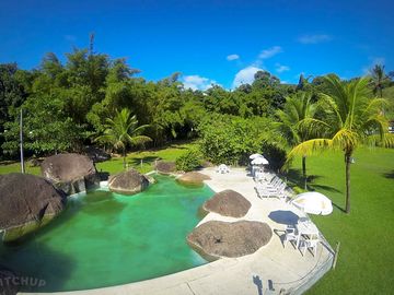 Swimming pool with shaded areas and sun loungers