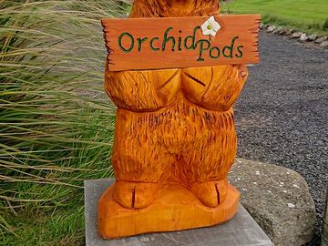 Our highland coo sign at the entrance to our carpark and pods