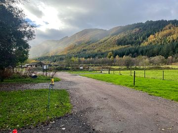 The site is surrounded by forested hills