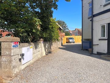 Driveway to side of main building to access the parking.