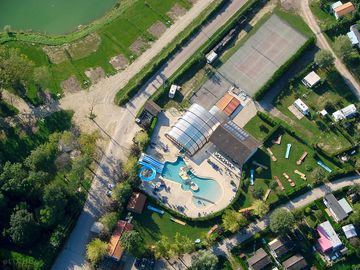 Drone view of the indoor and outdoor pool as well as the tennis court