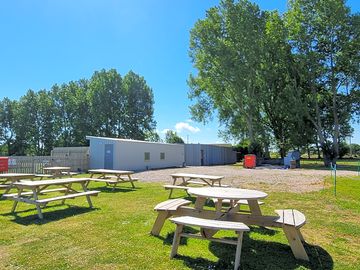 Picnic benches with a view to the outdoor archery and air rifle range