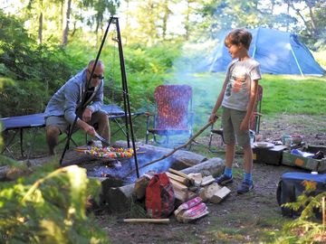 Family cooking over the campfire
