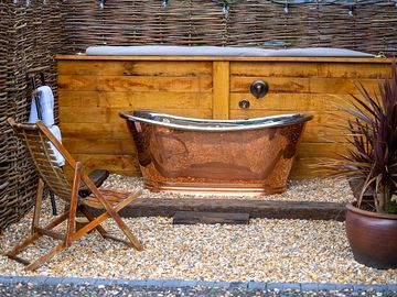 Private copper bath, outdoors with piping hot water