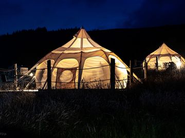 Luxury glamping bell tents, furnished with a comfortable double bed and various cosy amenities