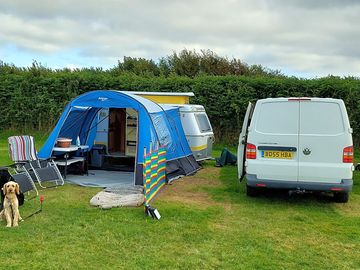 Spacious electric pitches with parking by the tent