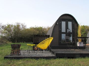 Outdoor area with bistro set and graveled fire pit.