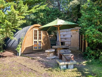 Exterior of the Yellow Pheasant pod that sleeps 4 showing the Scrub Shack and outside dining area.