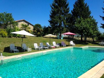 Swimming pool with loungers and parasols
