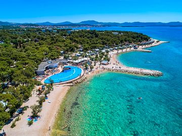 Aerial view of the beach, pool and pine forest