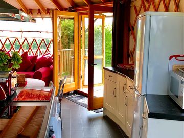 French doors open into the kitchen/dining area and the carpeted living space.
