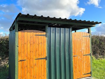 Outdoor push button gas showers with warm water.