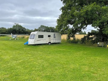 Caravan pitch under a large oak tree (added by manager 23 Jul 2021)