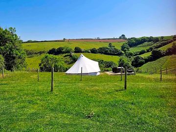 Bell tent surrounded by sloping countryside (added by manager 02 May 2024)