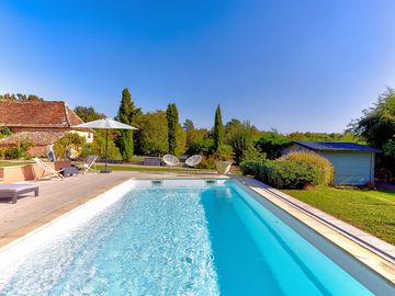 Swimming pool, sun deck and neatly kept gardens