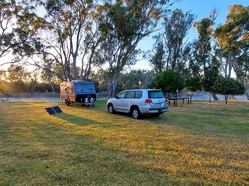 Camping area along the tree-lined river