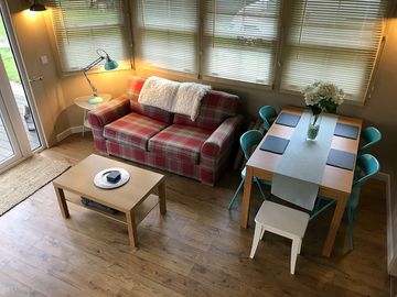 Dining table and lounge with sofa bed