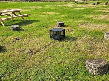 Each wild camping pitch has its own table, fire pit and log seats