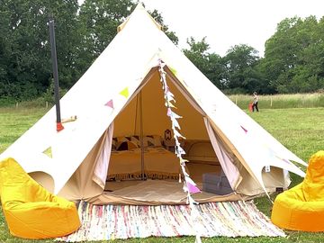 Standard bell tent containing one double air bed,2 single air beds.lantern,bunting and picnic table
