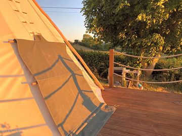 Tipi decking with views of hills and sunset