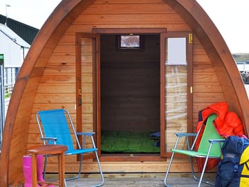 Camping pod with seating area on the deck