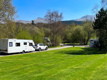 Grass and hardstanding pitches with mountain views