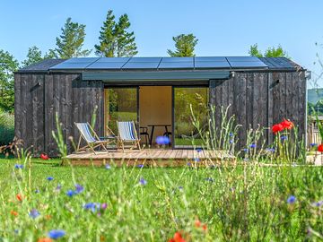 Microlodge surrounded by wild flowers