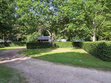 Spacious pitches shaded by trees and marked out by hedges