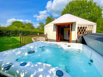 Hot tub on the decking outside the Willow and Ash yurts