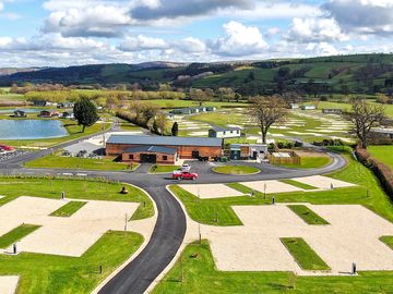 Drone view of the touring park and looking towards Arthur's Restaurant & Bar