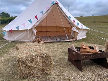 The classic 5 m bell tent complete with fire pit and bales, bunting and fairy lights. Easily sleeps