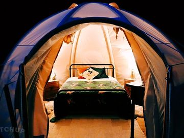Cosy bell tent lit up at night