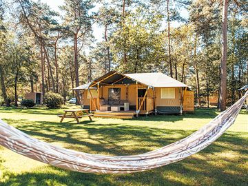 Exterior 7-person safari tent with sanitation facilities.