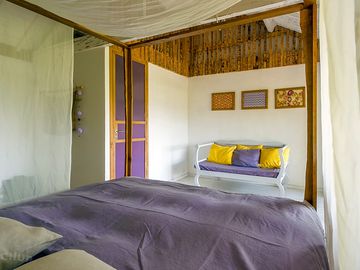King-size bed, luxurious bed linen and a seating area