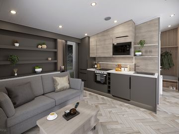 The living and kitchen area of the deluxe glamping pod and the double sofa bed