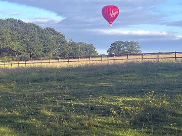 Hot-air ballon flying over the fields