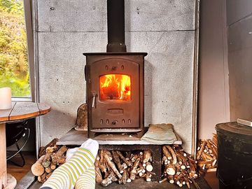 Relax and unwind in front of our cosy log burner - perfect for soothing tired feet after a hike