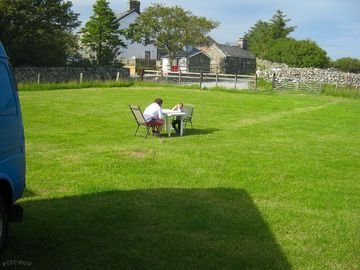 Camping field with the farmhouse in the background