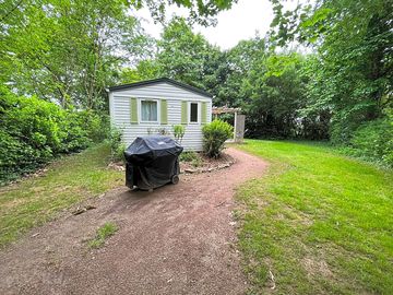 Caravan with barbecue in the garden