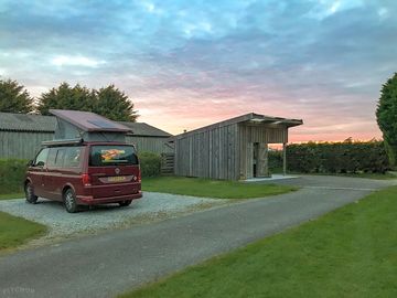 Sunset behind one of the hard-standing pitches and the washup/laundry block