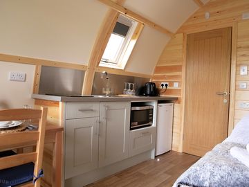Kitchen area with electric hob, combi microwave/oven, fridge freezer, kettle and toaster