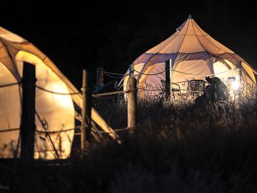 Luxury glamping bell tents, furnished with a comfortable double bed and various cosy amenities