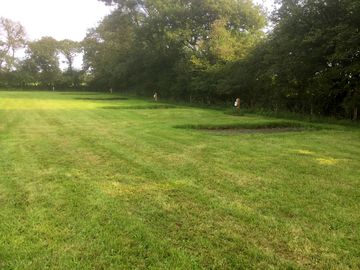 Hardstanding and grass pitch with electric hook ups.